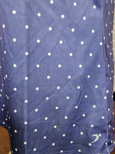 Load image into Gallery viewer, Close-up of polka dot fabric and hem logo